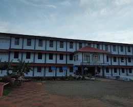 The main school building seen across the front lawn