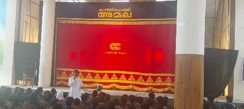 A speaker addressing students in the school auditorium