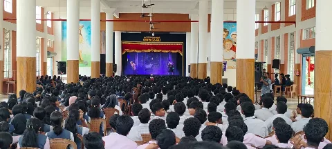 Students watching a stage programme in the school auditorium