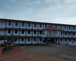 The main building seen across the front lawn
